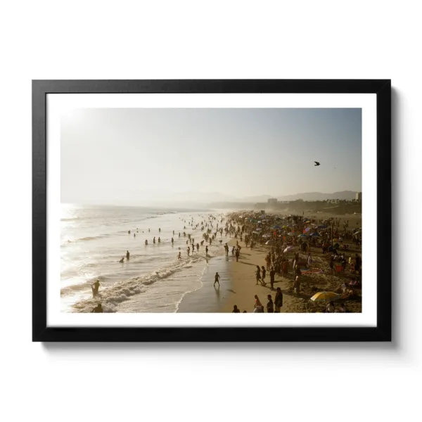 Beach picture of Santa Monica with many people bathing in the sea.