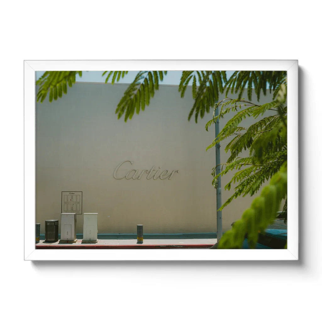 Bildaufnahme von einer beigen Wand mit großem Cartier Schriftzug.