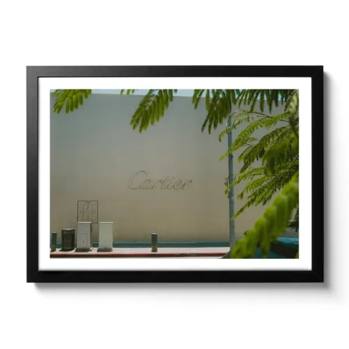 Bildaufnahme von einer beigen Wand mit großem Cartier Schriftzug.