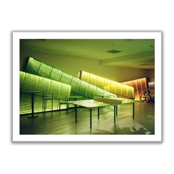 Image of a table tennis table illuminated with green neon lights