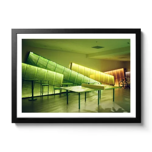 Image of a table tennis table illuminated with green neon lights