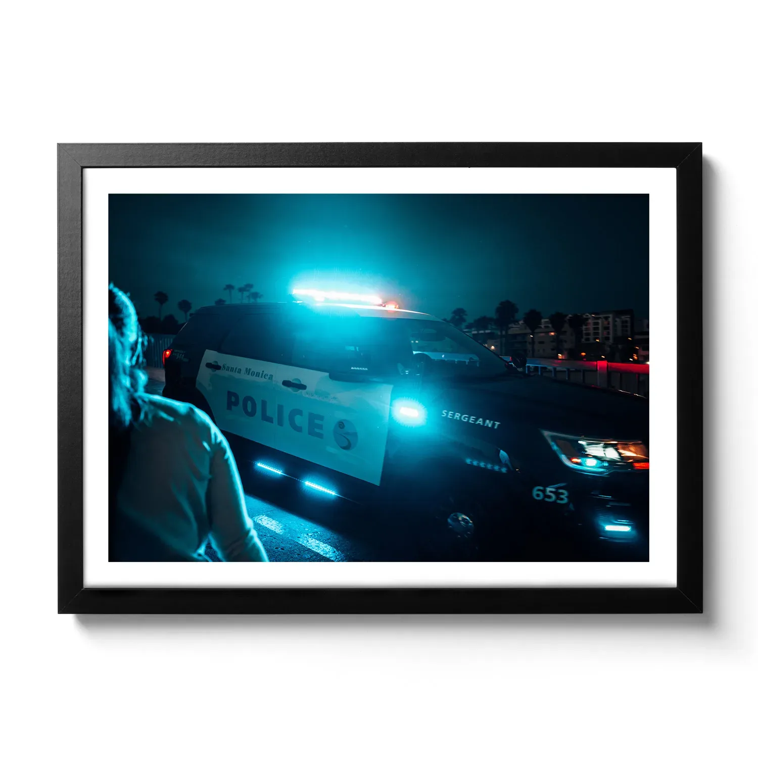 Image of an American police car at night that has just activated the siren. Blue neon look.