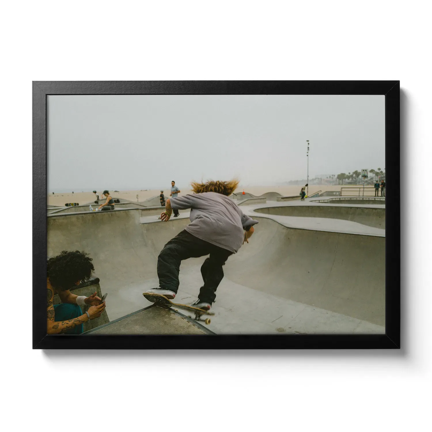 Skater Boys Skate boarder cruising in the half pipe of Venice Beach.