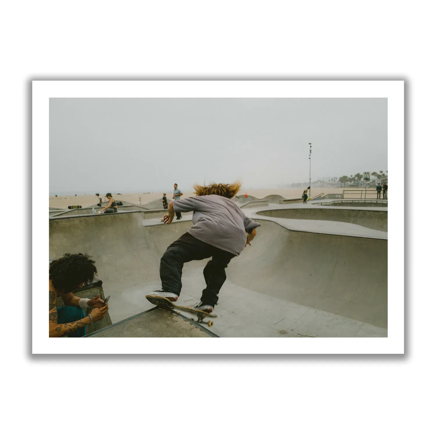 Skater Boys Skate boarder cruising in the half pipe of Venice Beach.