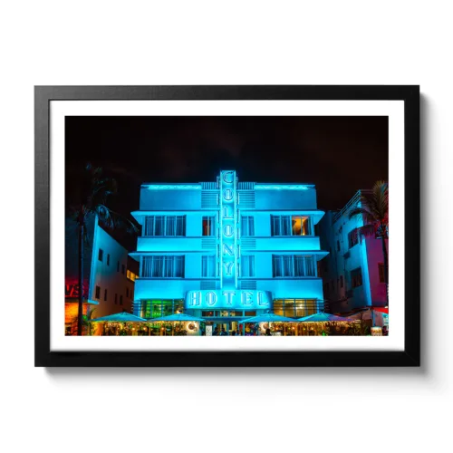 Image taken at night from the Colony Hotel Miami. Blue neon lights and palm trees