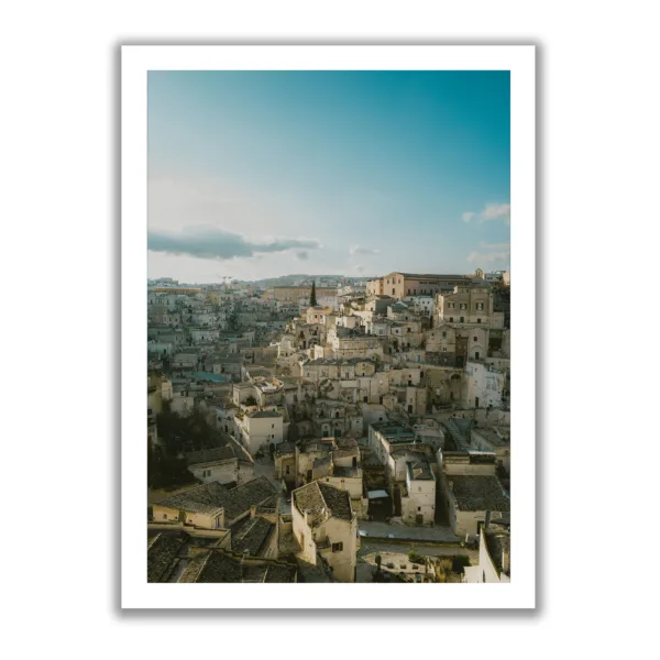 Skyline view of Matera (Italy) in portrait format. Blue sky and light sunset mood